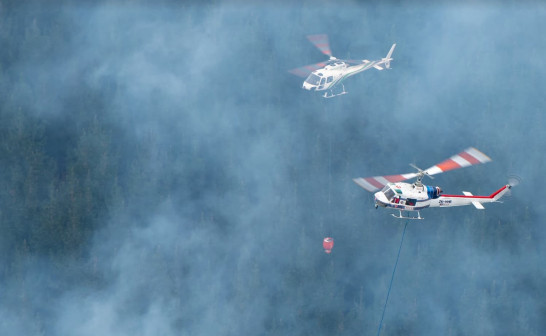 twi white helicopters bearing water