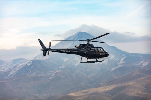 helicopter in the sky with mountain background